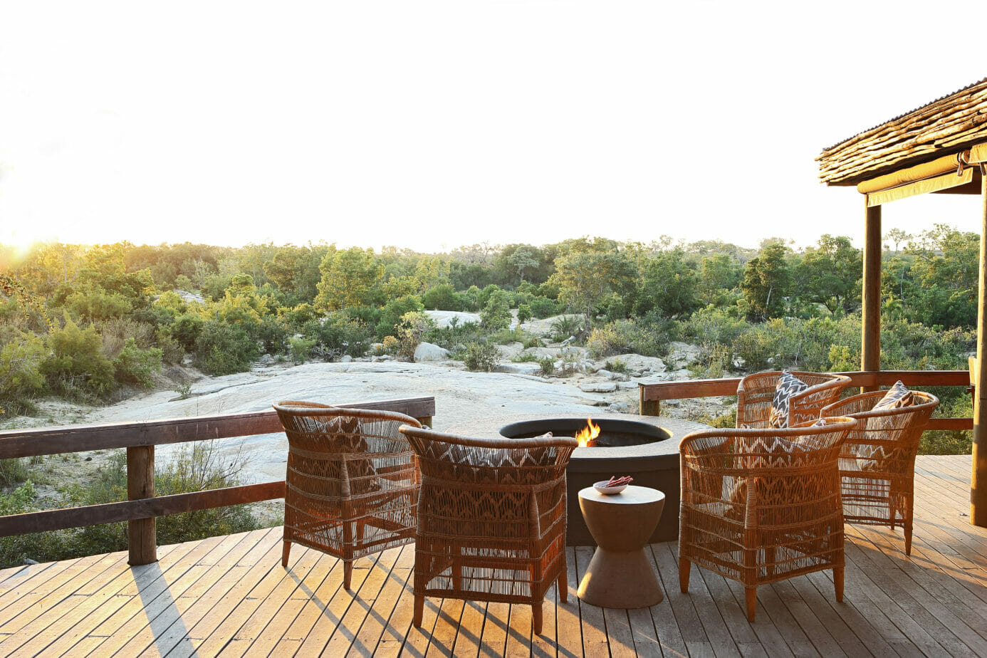 Londolozi Founders Camp Deck and Fireplace with View of Sand River at Sunset